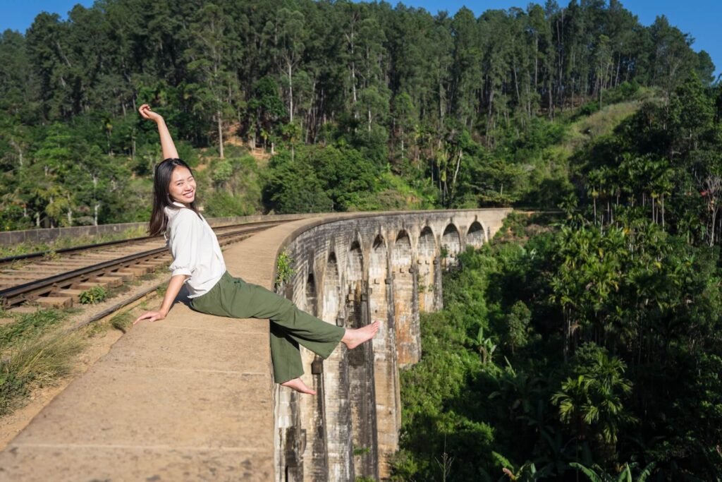 relaxed-asian-woman-sitting-on-bridge-dangling-leg-2026-01-11-11-11-45-utc