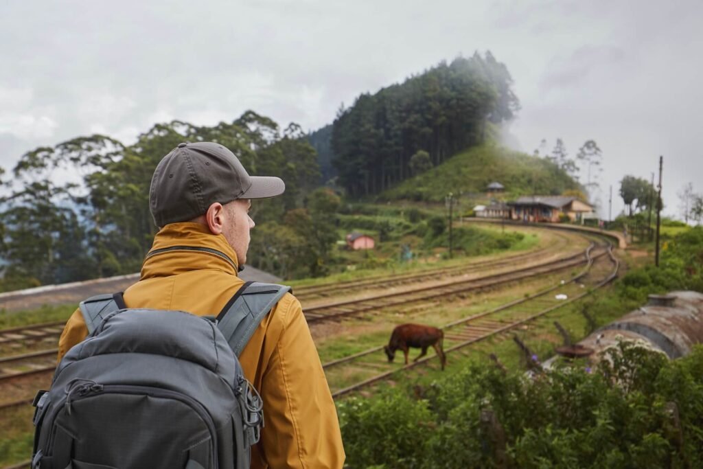 traveler-with-backpack-looking-at-rural-railroad-s-2026-01-08-01-41-54-utc