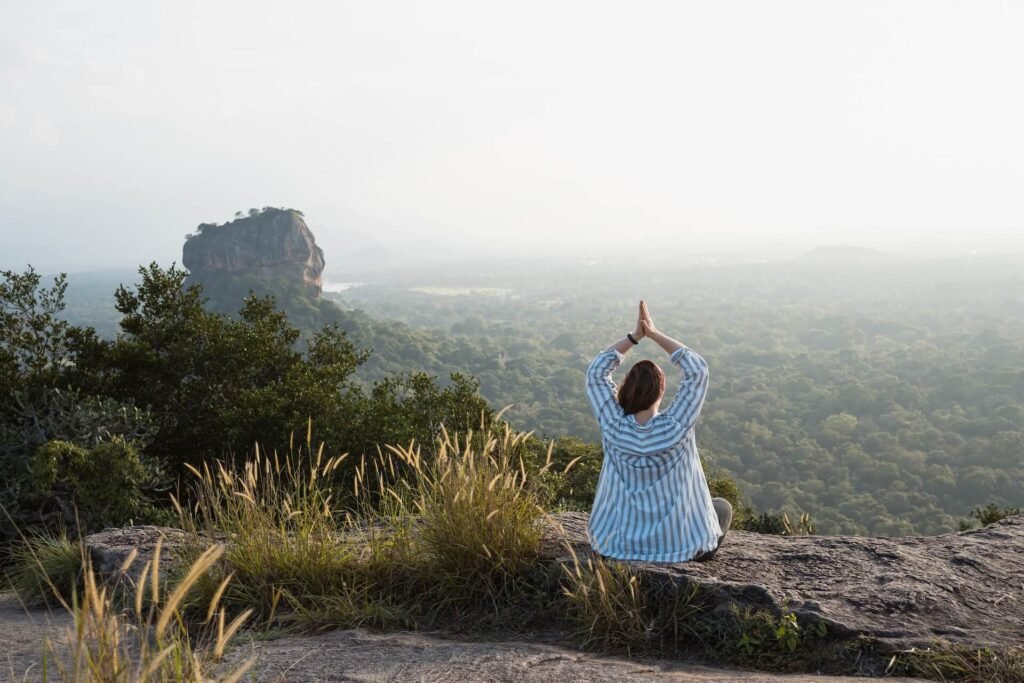 woman-doing-yoga-at-sunset-with-scenic-view-sigiri-2026-01-09-01-02-33-utc