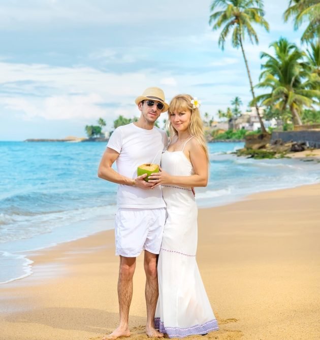a-man-and-a-girl-on-the-beach-are-drinking-coconut-2026-01-06-10-09-19-utc